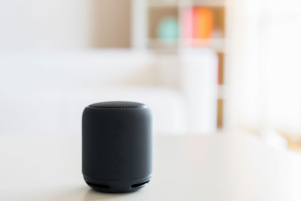 A smart speaker placed on a surface.