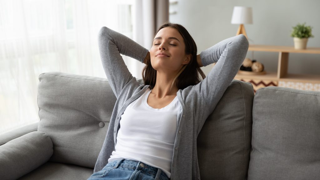 Woman relaxing on her sofa.