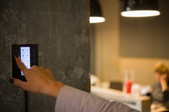 A person adjusting their home lighting with automated technology.